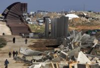 French Military officials supervise construction of underground wall in Egypt.
